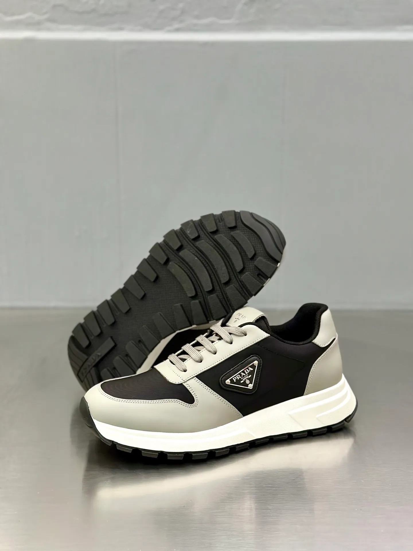 💰740 Prada/Prada men's new mesh stitching sneakers. This sneaker presents a modern version, reinterpreting the brand's archive style with clean lines and smooth details. The shoes are made of calf leather and technical fabric, with a triangular metal logo on the outside, bright TPU decoration on the heel, and a longer and padded inner heel design for a more comfortable fit. The tongue is decorated with a silk-screen logo, and is paired with a hollow rubber sole on the heel. The full cowhide lining comes standard with logo cowhide foot pads, making the upper foot taller, more comfortable, and versatile! Comes with full original packaging! Size: 39-40-41-42-43-44 standard leather shoe size (45 can be customized and does not support returns)